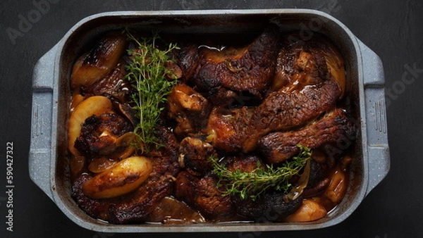 Fototapeta A steak braised herbs, served with boiled  potatoes garnished with fresh oregano.