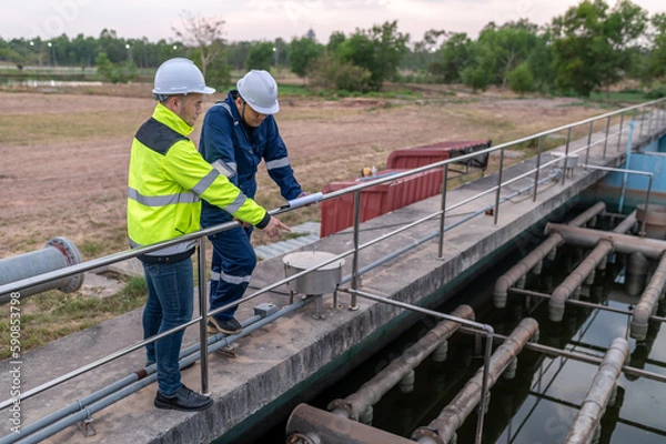 Fototapeta Environmental engineers work at wastewater treatment plants,Water supply engineering working at Water recycling plant for reuse,Technicians and engineers discuss work together.
