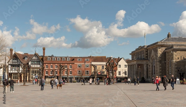 Obraz Salisbury, Wiltshire, England, UK. 2023. People walk on Market Place in the city centre surrounded with historic buildings, The Guildhall, shops and offices.