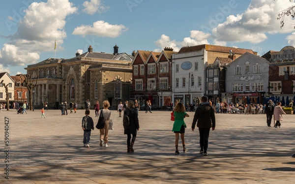 Obraz Salisbury, Wiltshire, England, UK. 2023. People walk on Market Place in the city centre surrounded with historic buildings, The Guildhall, shops and offices.