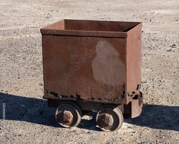 Fototapeta Rusty old mine wagon or cart on wheels