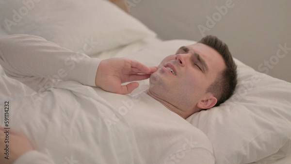 Obraz Young Man with Toothache Lying in Bed