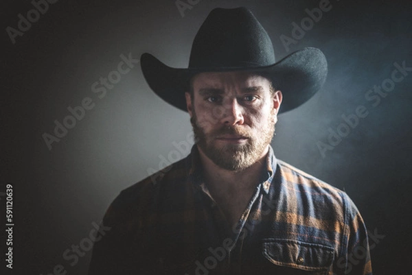 Obraz Rugged man in cowboy hat.  Studio session.