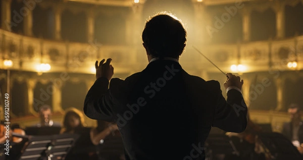 Obraz Back View Cinematic shot of Conductor Directing Symphony Orchestra with Performers Playing Violins, Cello and Trumpet on Classic Theatre with Curtain Stage During Music Concert
