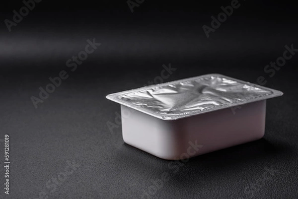 Fototapeta Rectangular plastic box with yogurt or cheese hermetically sealed with a foil lid