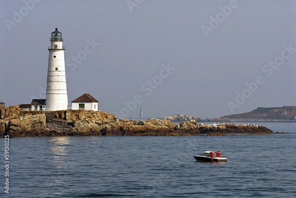 Fototapeta Fishing Near Boston Harbor Lighthouse as Fog Lifts to Display Sunlit Tower