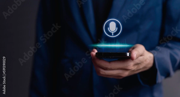 Fototapeta businessman using utilizes his smartphone as an AI assistant, effectively issuing voice commands through its microphone symbol, enhancing productivity with cutting-edge technology.