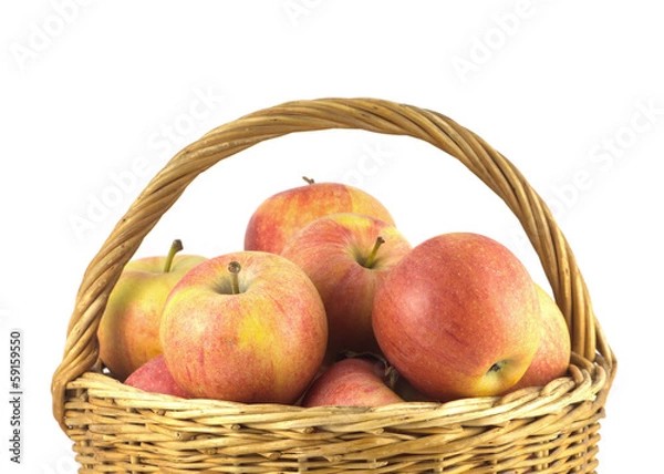 Fototapeta Red and yellow ripe apples in wicker basket isolated close up