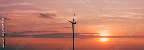 Fototapeta Renewable energy. a windmill for generating electricity from the wind and the sunset behind.  keep environment