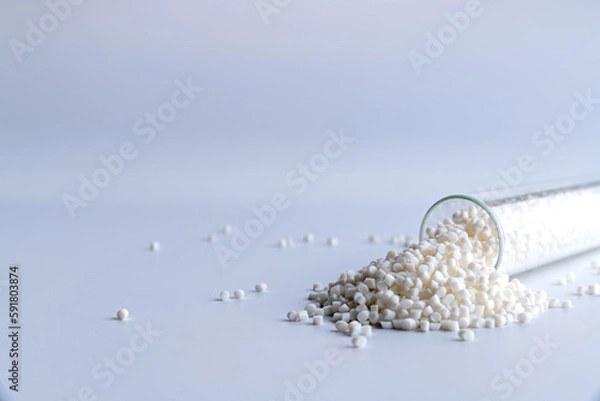 Fototapeta Small pieces of crushed plastic. Crushed bottle caps for recycling. Plastic waste that will be mixed with plastic vergin. Concept reducing plastic.