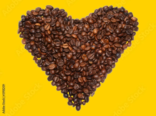 Fototapeta Beans of coffee in the form of heart on a yellow background