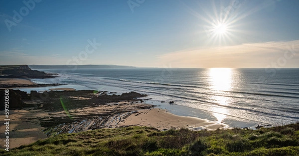 Fototapeta Landscape image of Cornish beach in Summertime at sunset