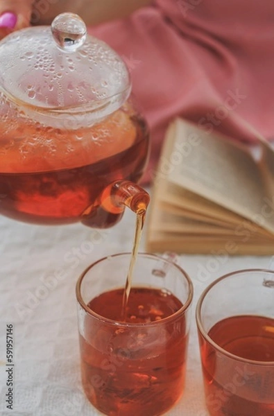 Obraz Picnic in spring under a tree in nature. A gourmet picnic in the park, laid out on a carpet around wine, cheese, fresh fruit, croissants.