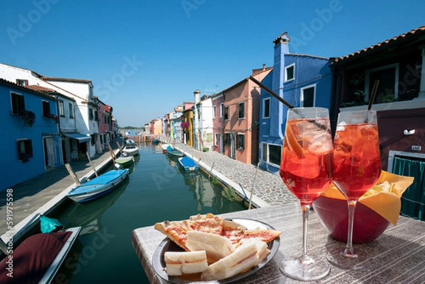 Fototapeta Spritz for two with snacks in Burano with the canal in the background