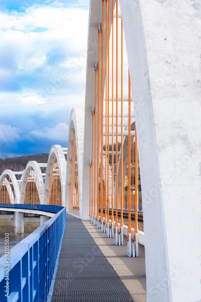 Obraz Details of modern railroad bridge over the river in Poland. Path for staff of railway.