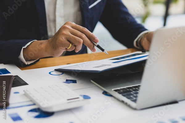 Fototapeta Businessman working on documents on the desk, data analysis of financial figures and business investments.