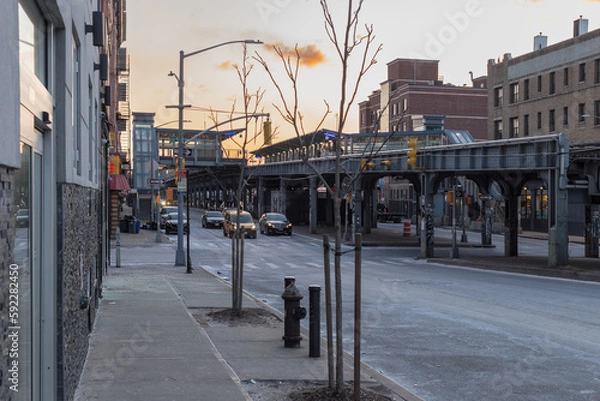 Fototapeta Cold morning on street in Brooklyn with Long Island Railroad train station passing through background