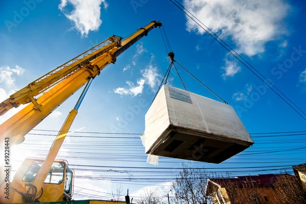 Fototapeta Żuraw przemysłowy obsługujący i podnoszący generator elektryczny