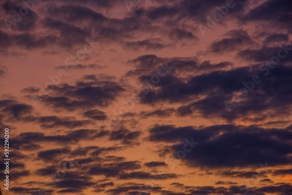 Obraz Dark clouds at sunset with orange sky