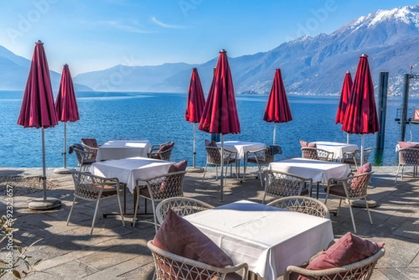 Fototapeta Empty street cafe vith the view to Lago Maggiore on a sunny early spring day