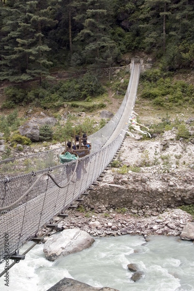 Obraz porters crossing a suspension bridge - nepal