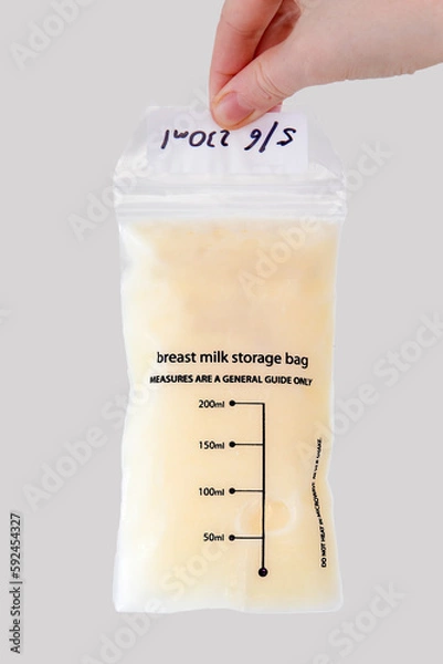 Fototapeta Samples of frozen expressed human breast milk in a plastic sachet with date marked on it and other measurements for carer's notification.
