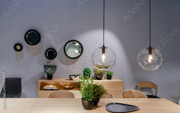 Fototapeta Typical interior decoration of a modern room of a house with table, chairs and lights