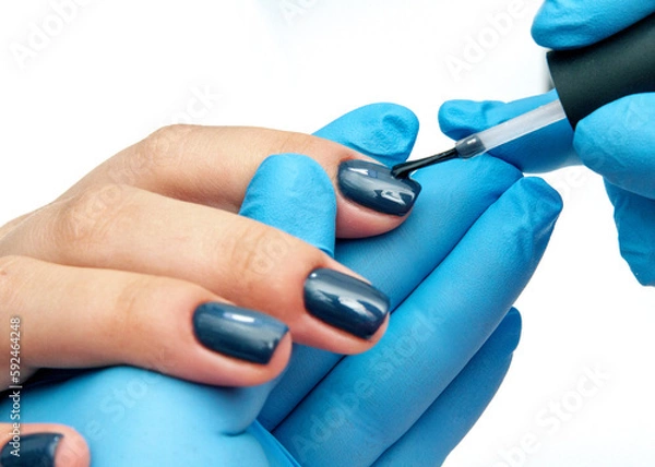 Obraz Manicurist does a manicure