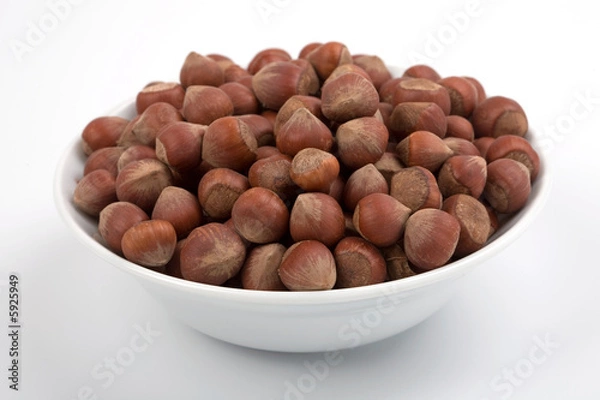 Fototapeta Hazelnuts on white bowl