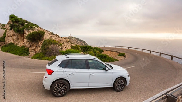 Fototapeta Car on the curve with a view of sea and mountain.
