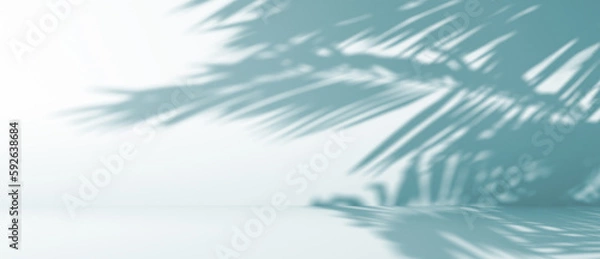 Obraz blurred shadow of palm leaves on a blue wall. Abstract minimal background for a product presentation. Summer and spring seasons