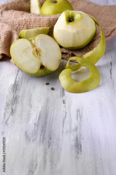 Fototapeta Apples and sackcloth on  on wooden background