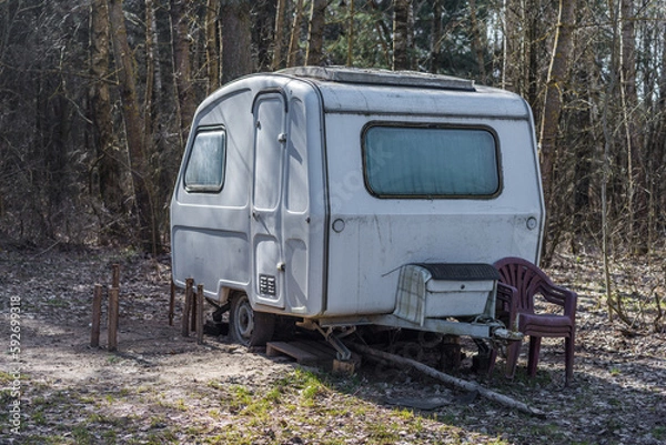 Fototapeta old caravans parked in the forest