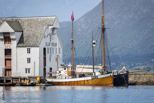 Fototapeta Historic sailing boats parking at an old dock in the city of Ålesund in Norway