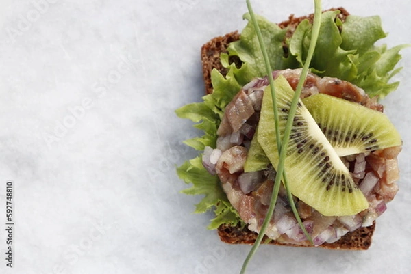 Fototapeta Herring tartare on a slice of rye bread