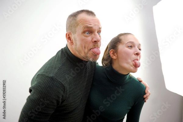 Fototapeta Hi! Portrait of crazy bloggers playful senior couple in casual outfit shooting selfie on front camera outside gesturing and tongue out enjoying walk having fun. Leisure rest relax