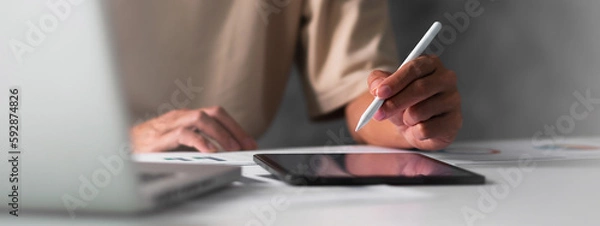Fototapeta Close up of student hand using electronic pen with tablet. education e-learning concept for banner