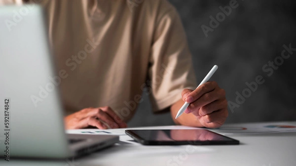 Fototapeta Close up of student hand using electronic pen with tablet. education e-learning concept