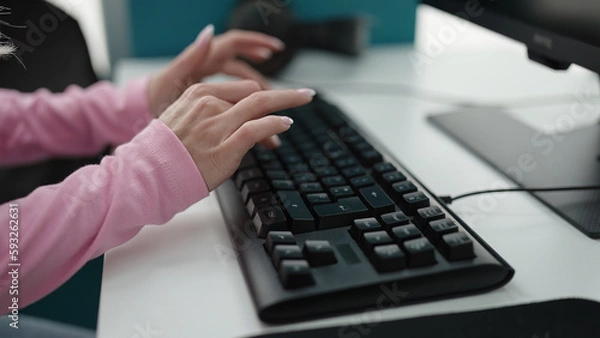 Fototapeta Young blonde woman student using computer studying at library university