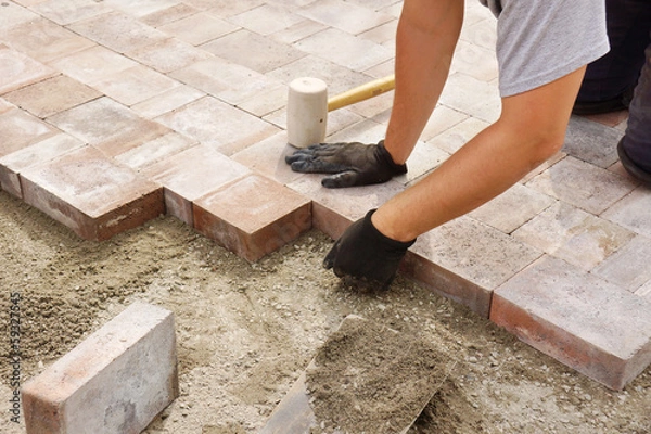 Obraz Worker installing paver