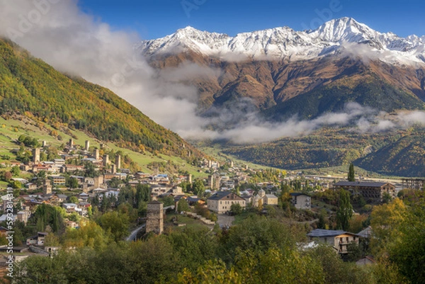 Obraz Svan towers in Mestia village with snow mountain range background in sunny day during autumn period