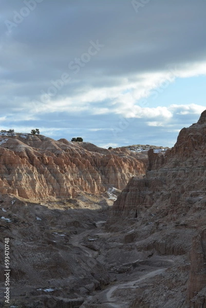 Fototapeta Cathedral Gorge State Park on a cold day in December with fresh snow, located in a long, narrow valley in southeastern Nevada, where erosion has carved patterns in bentonite clay