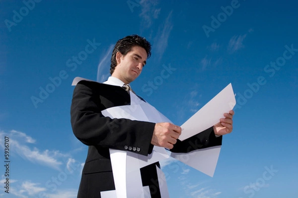 Fototapeta Busy businessman looking over paperwork