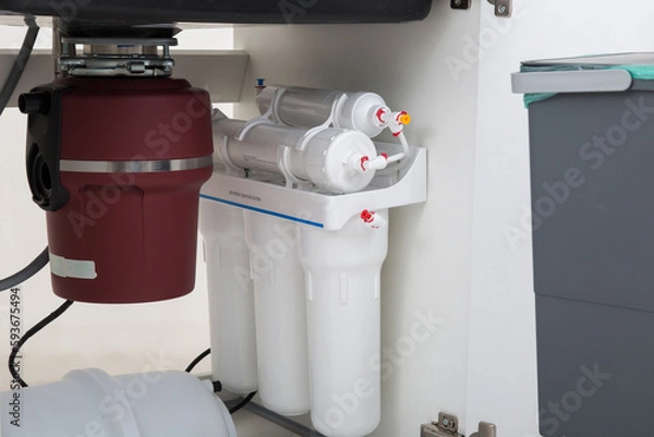 Fototapeta Garbage disposal, erator and osmosis system inside kitchen cabinet
