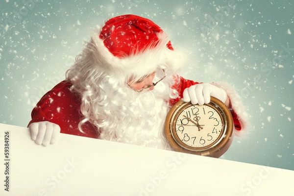 Fototapeta Santa Claus  with white blank banner holding a clock showing sev
