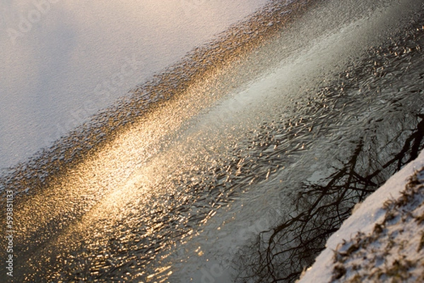 Fototapeta The snow and ice. The background consisting of ice and snow on the frozen river.