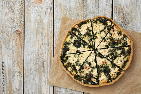 Obraz Delicious homemade spinach quiche on rustic wooden table, top view