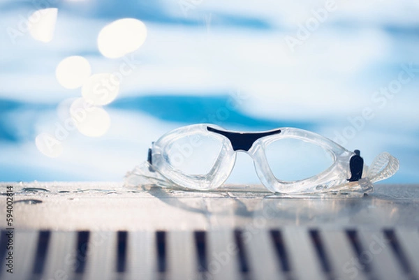 Obraz Close-up shot of swimming goggles on swimming pool, text input background in swimming pool.