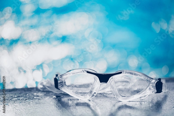 Obraz Close-up shot of swimming goggles on swimming pool, text input background in swimming pool.