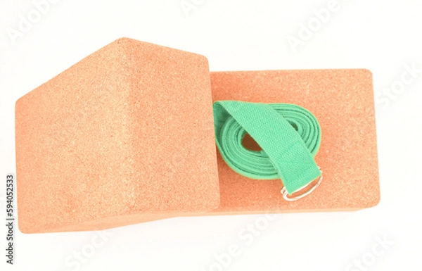 Fototapeta Two cork yoga blocks and green strap isolated on a white background
